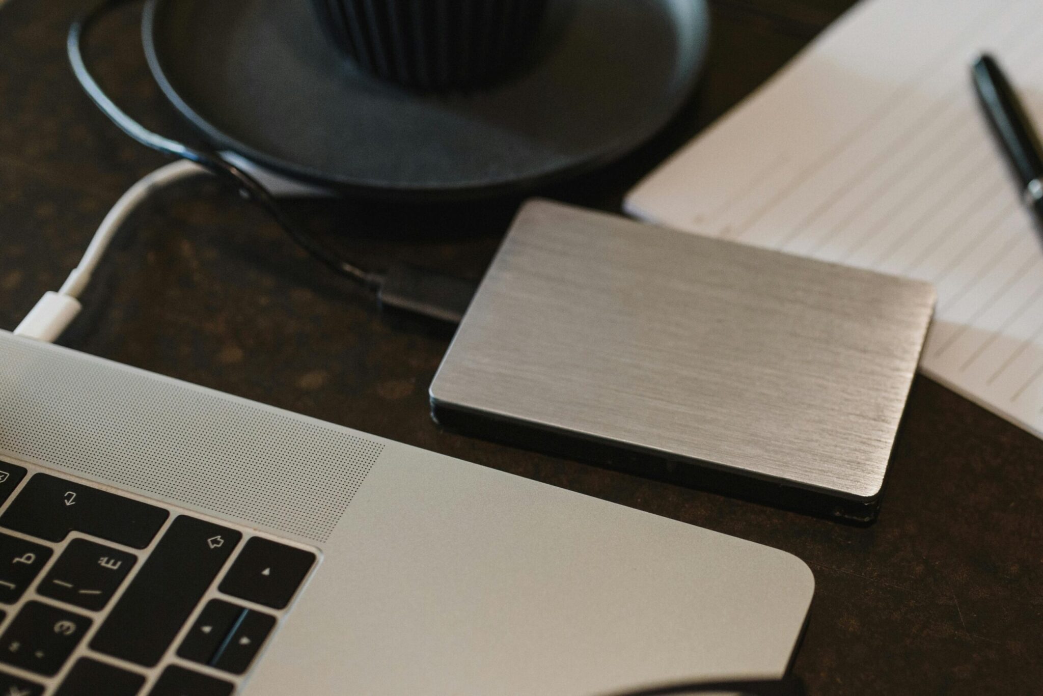 Best-Practices-For-Secure-Data-Backup-scaledjpg | ALCON DTS: Austin, TX Best Managed IT Support Services Free Closeup of an external hard drive connected to a laptop with a USB cable on a desk. Stock Photo