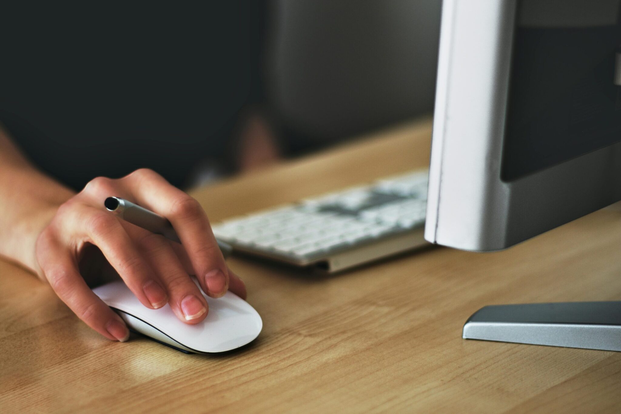 Beyond-Licensing_-How-to-Stop-Wasting-Money-on-Your-Microsoft-365-Security-and-Copilot-Add-Ons-scaledjpg | ALCON DTS: Austin, TX Best Managed IT Support Services Free A hand using a wireless mouse at a modern desk setup with a computer and keyboard. Stock Photo
